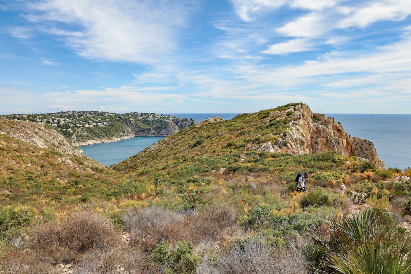 A father and child approach the Mirador de Llevant lookout in Javea, Spain on one of the best walks in the region.