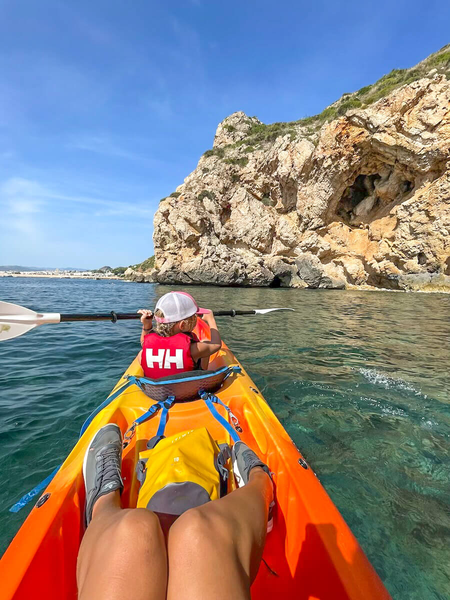A child on a kayak tour with a guide in Javea, Spain.