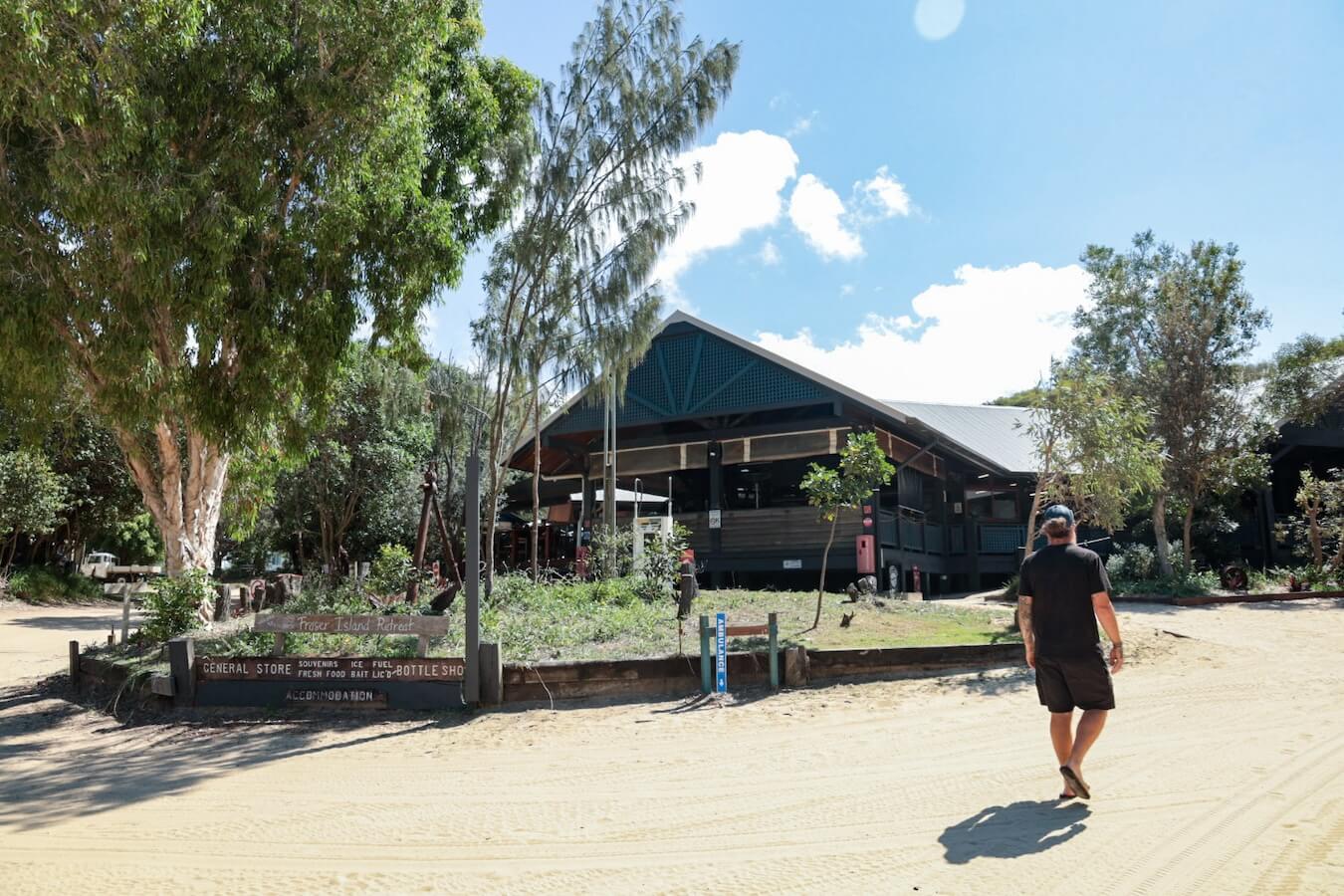 A man walks towards the restaurant at Happy Valley on K'gari