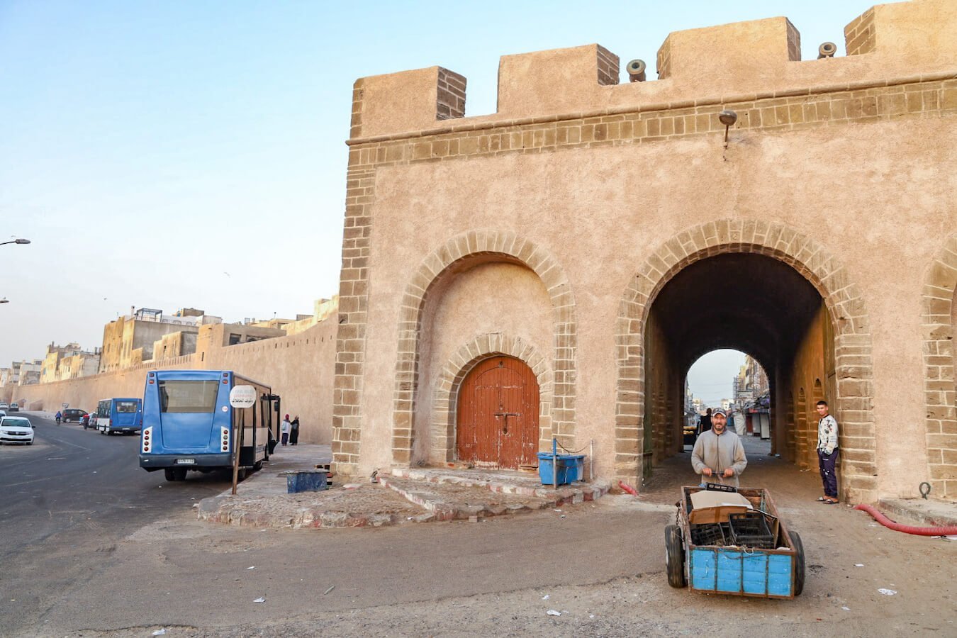 Bab Doukkala and man walking a cart early in the morning