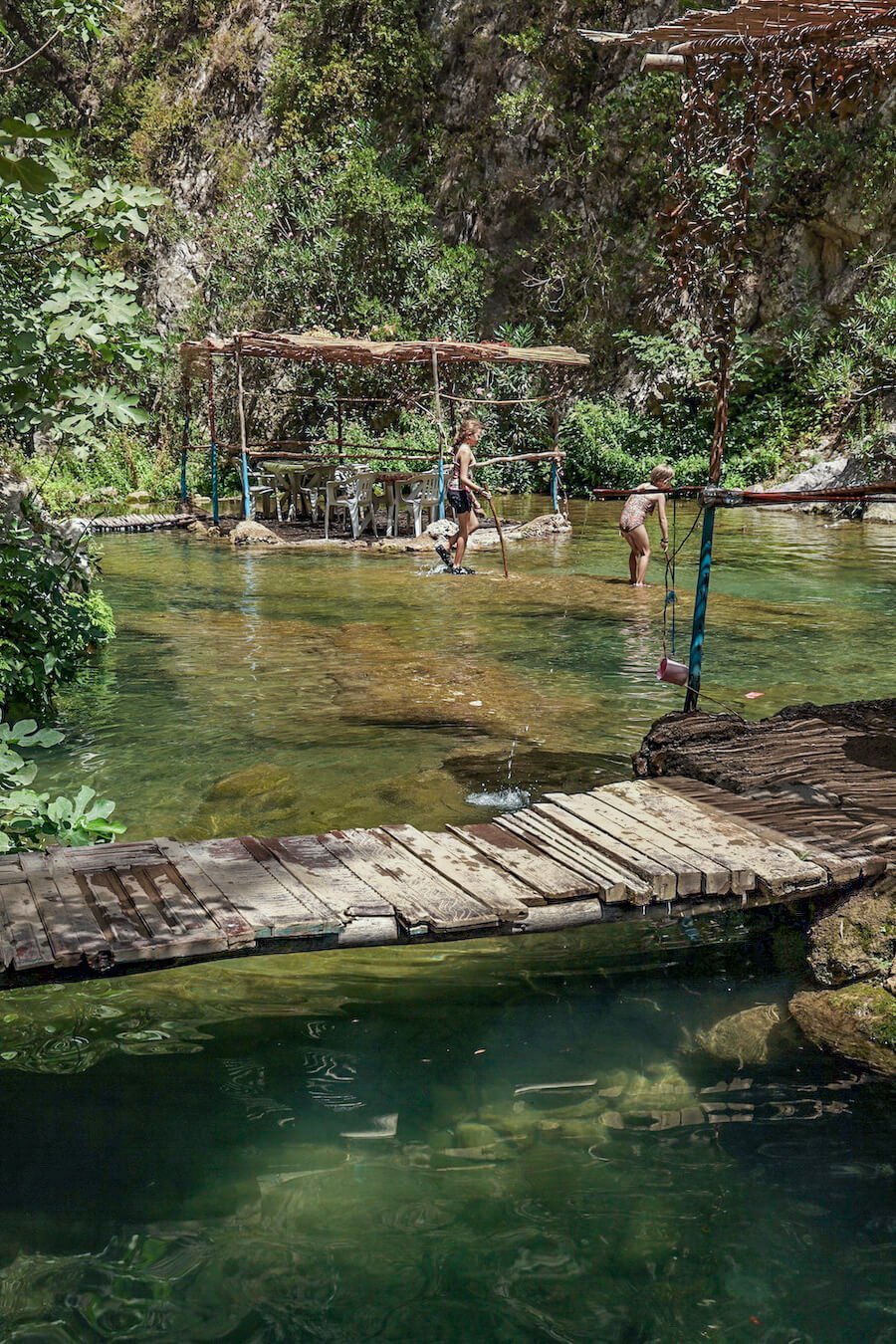 Children play in the cool river water of  Akchour in the Rif Mountains of Morocco.
