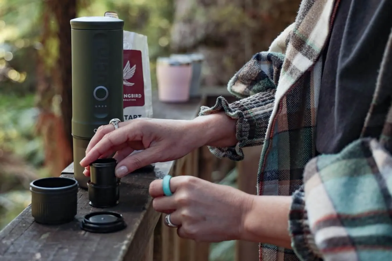 A person fills coffee grinds in the OutIn filter basket in preparation to make an espresso.