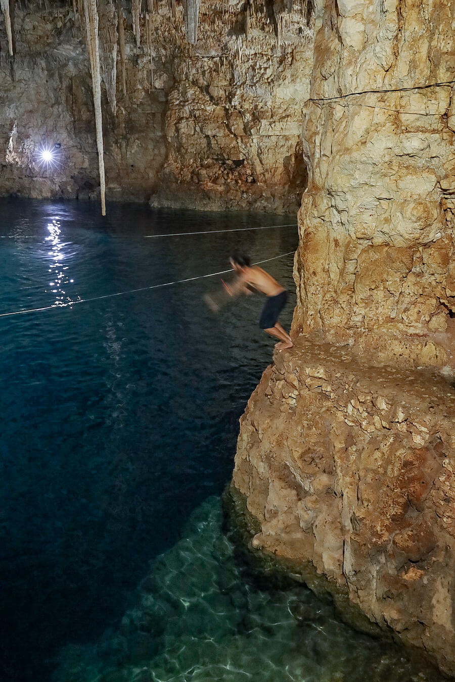 A man jumps into Palomitas Cenote