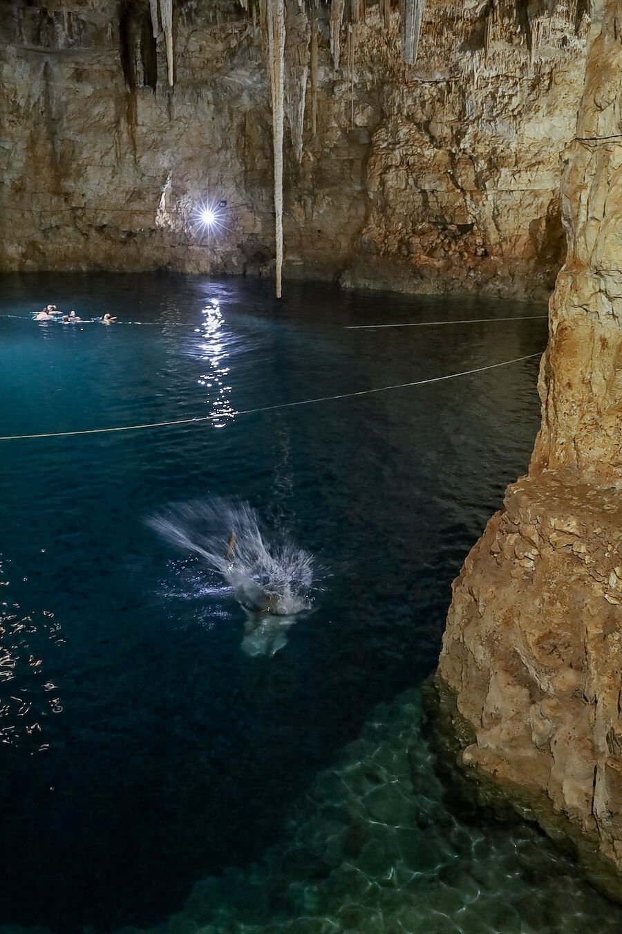 A man jumps into Palomitas Cenote
