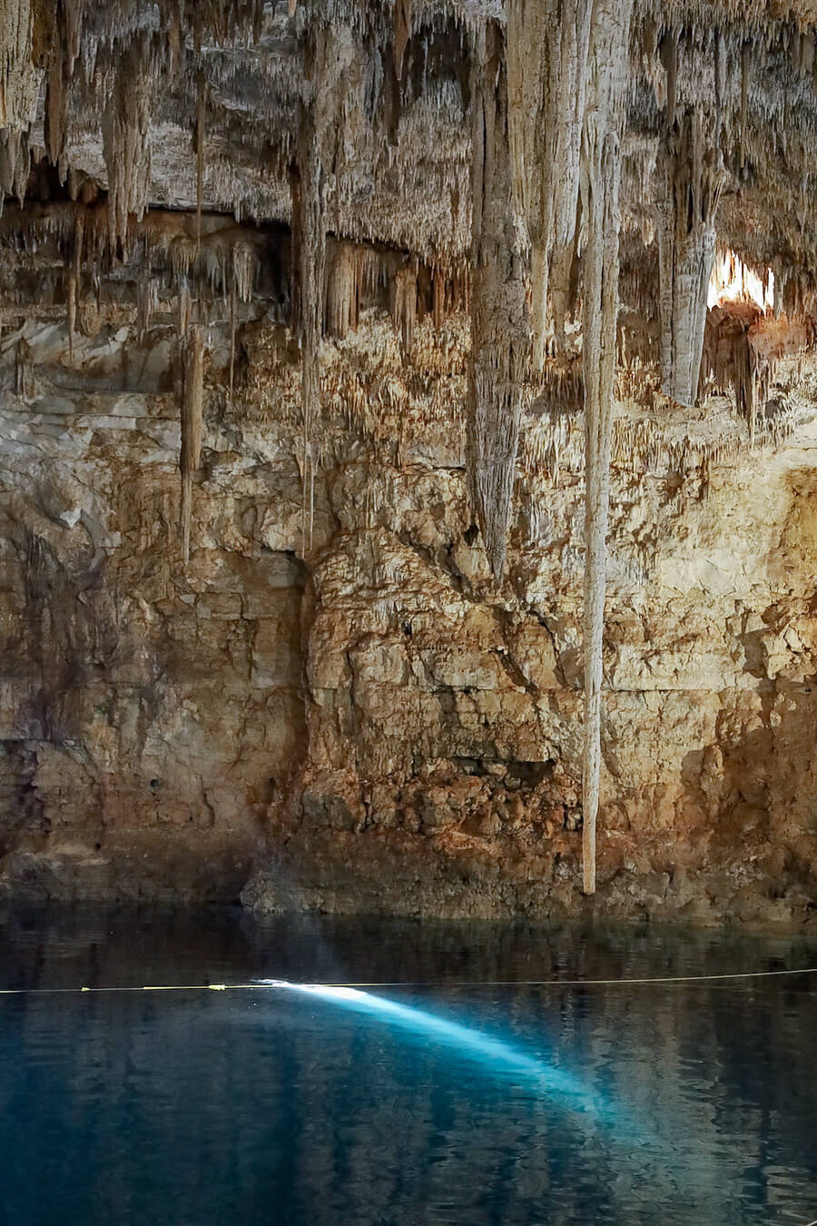 The beam of sun light that enters through the small opening in the closed Palomitas Cenote