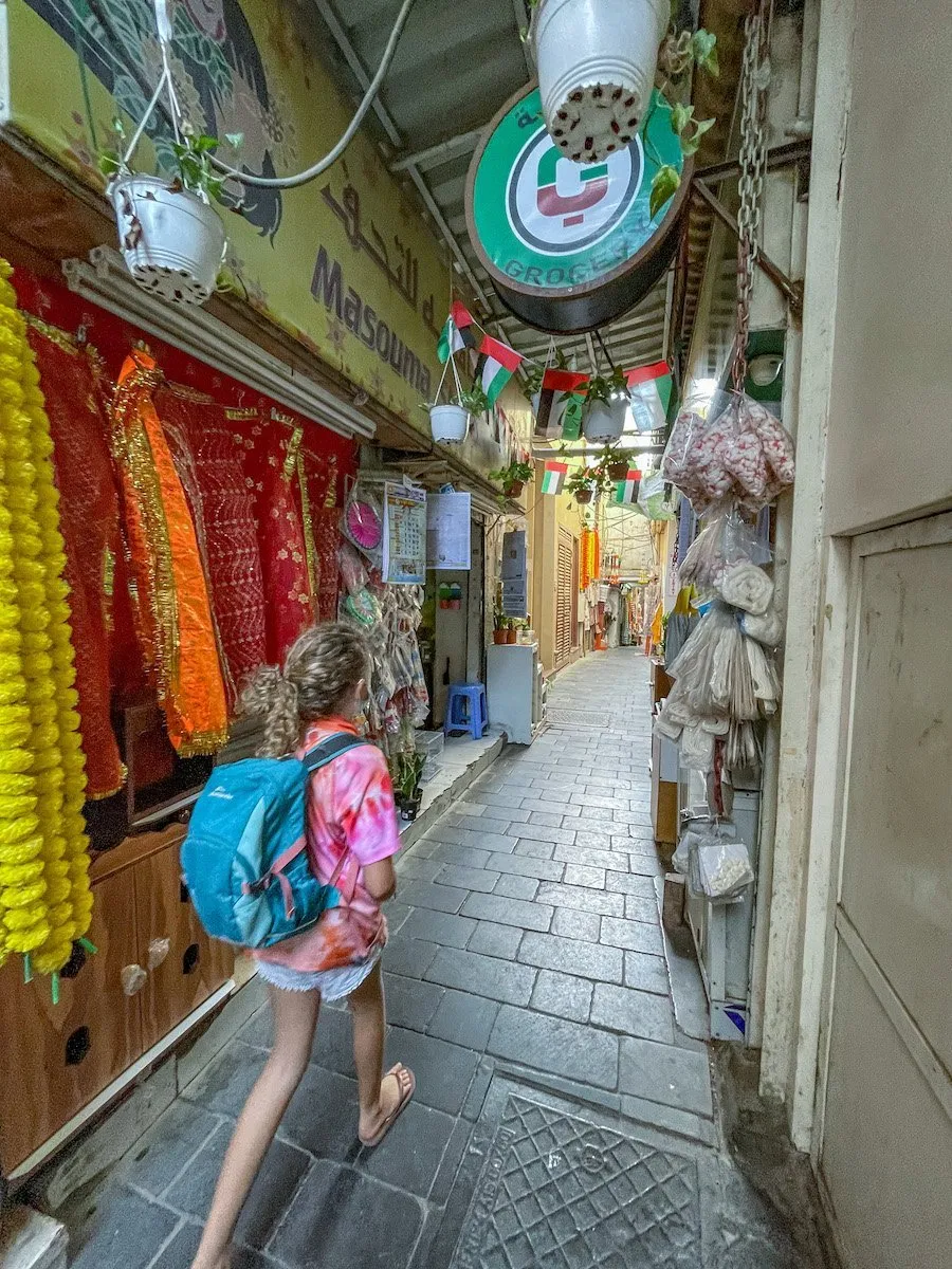 girl walking through the Shiva Temple walkways at Dubai Creek