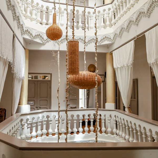 A beautiful riad in Essaouira, Morocco. Lanterns hang through the boutique floors of Lyon Mogador riad.