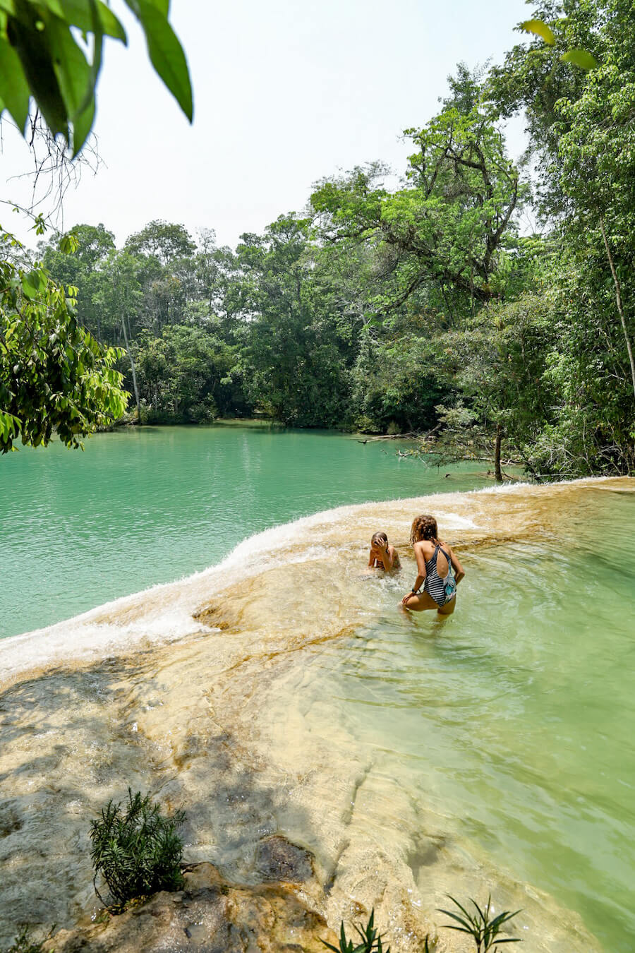 A large aqua coloured laguna and waterfall near Palenque
