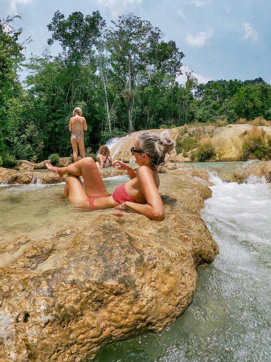 A mother and her two daughters relaxing in a set of natural fresh water pools, in Roberto Barrios, Palenque. 
