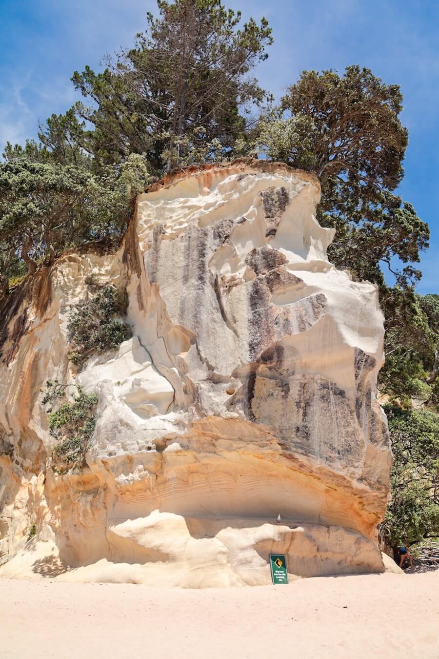 A sign reminding visitors to take care for falling rocks at Cathedral Cove.