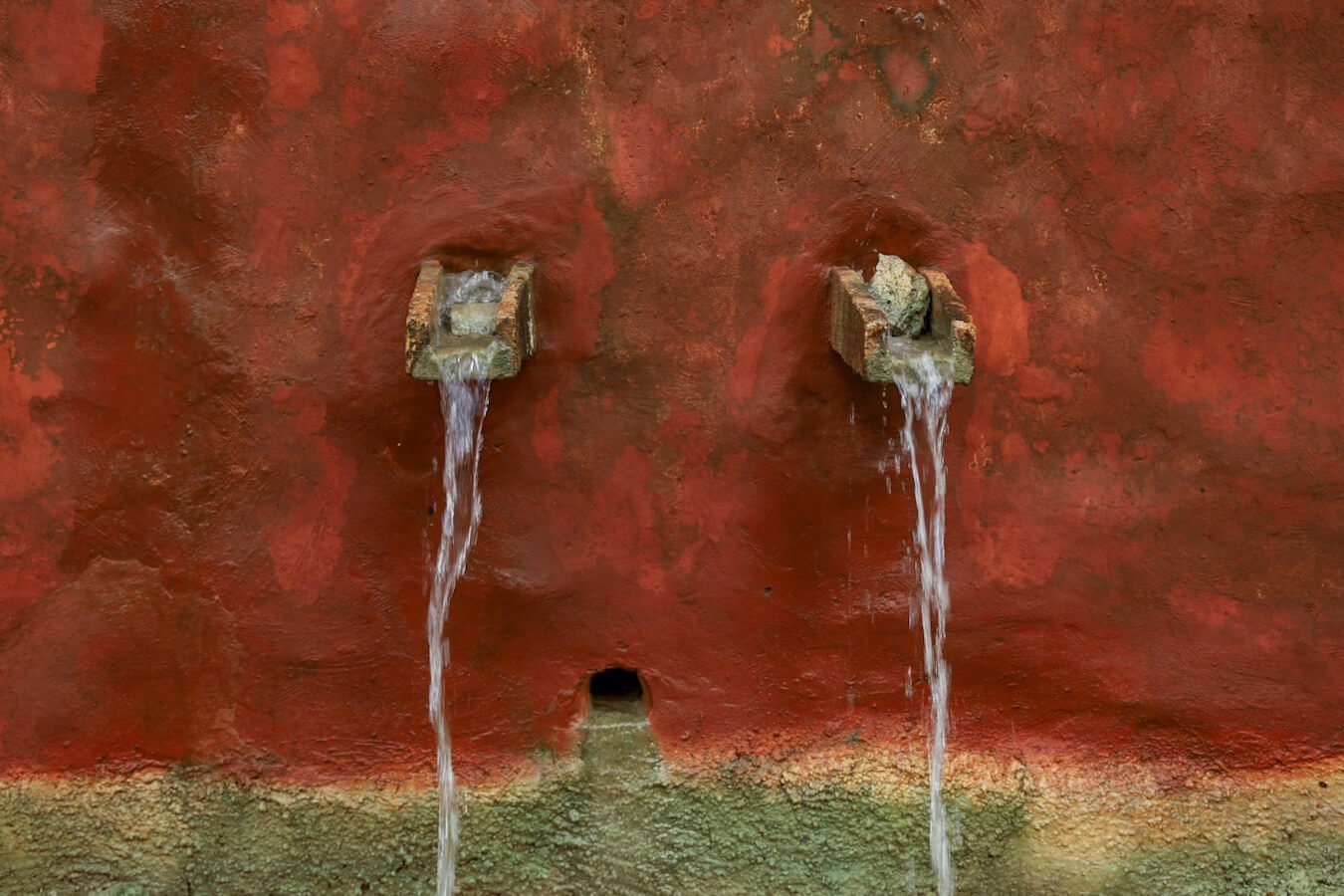 Water pours from makeshift taps at the entrance of Hacienda Selva Maya near Valladolid.