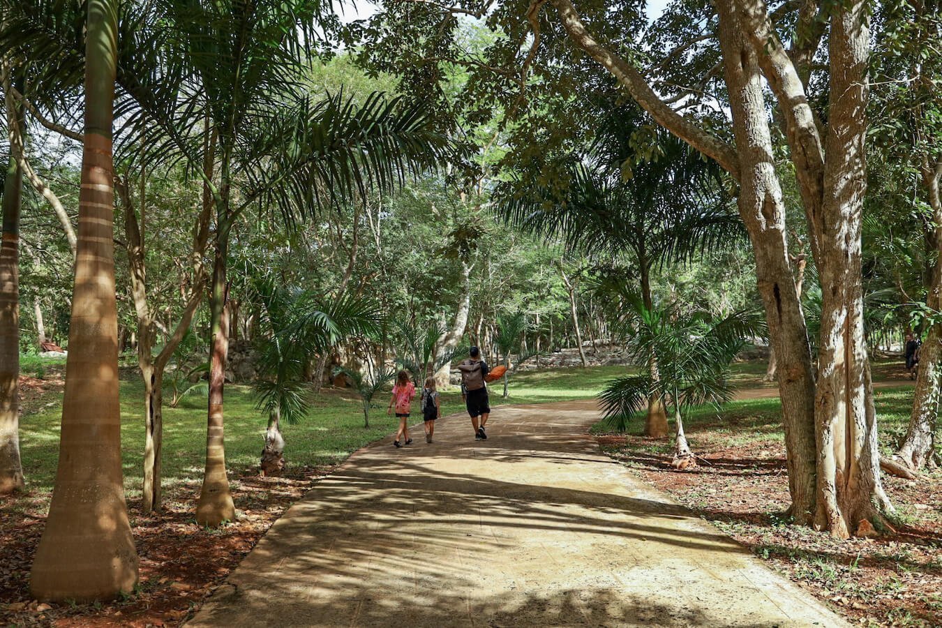 A family walk the walking trail in Hacienda Selva Maya after swimming at Saamal Cenote near Valladolid.