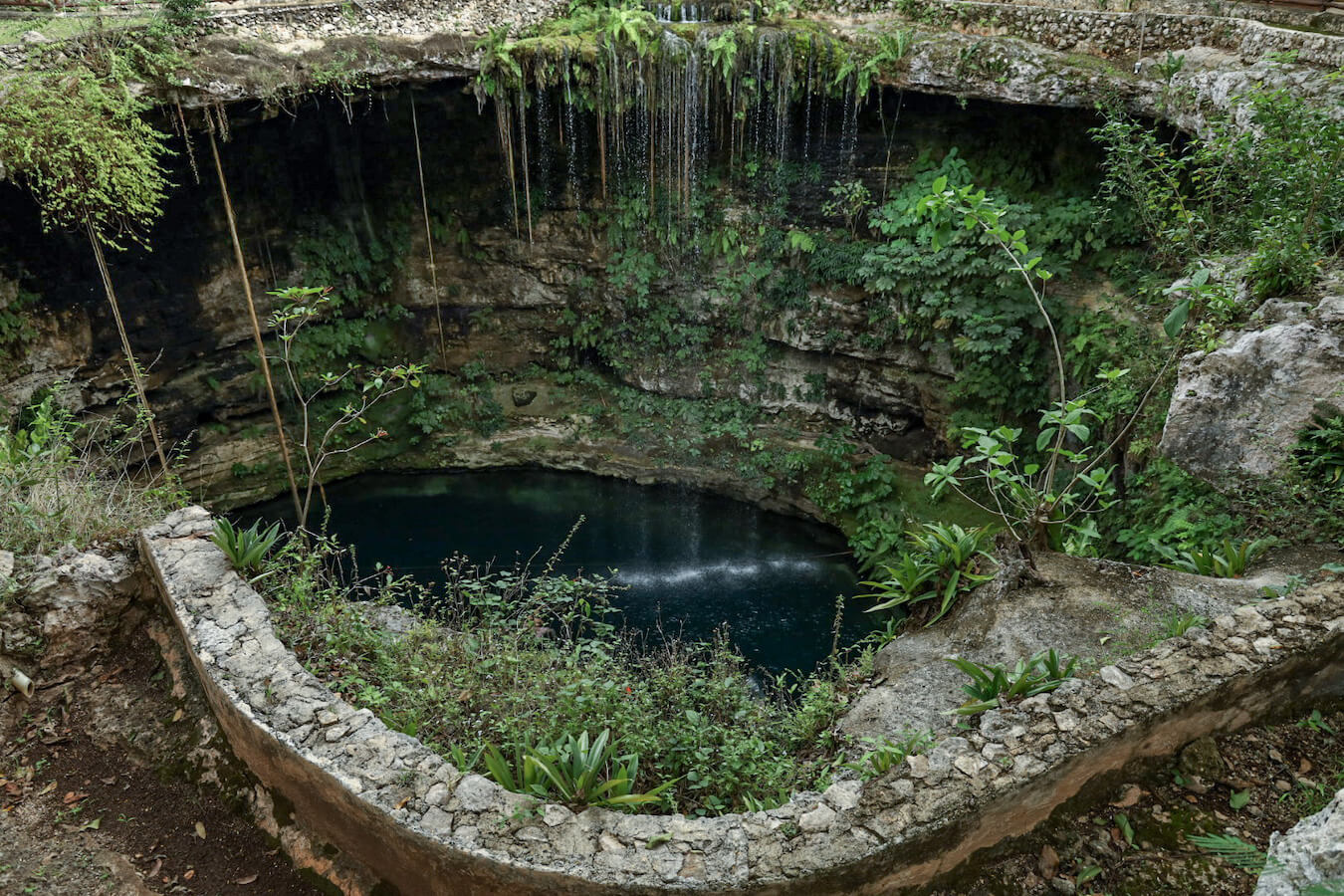 Views of the Saamal cenote and the cascade down into the cenote at Hacienda Selva Maya in Valladolid, Mexico.