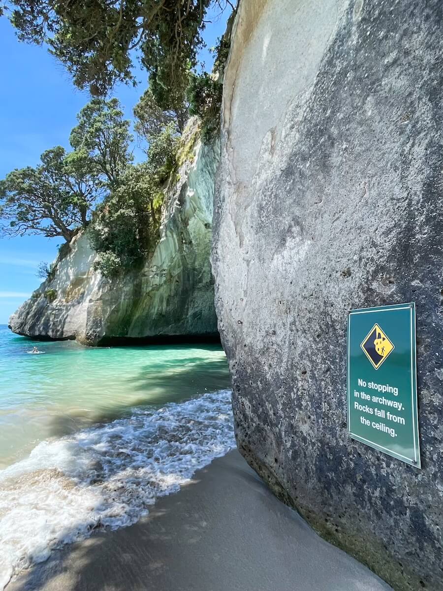 A sign reminding visitors to take care for falling rocks at Cathedral Cove.