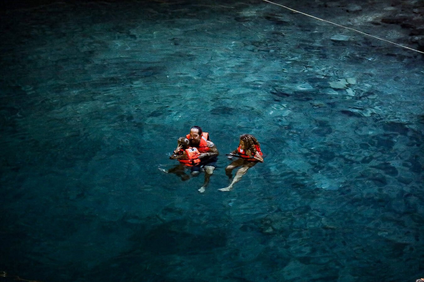 A family swim in the turquoise water of Samula Cenote at Dzitnup in Valladolid