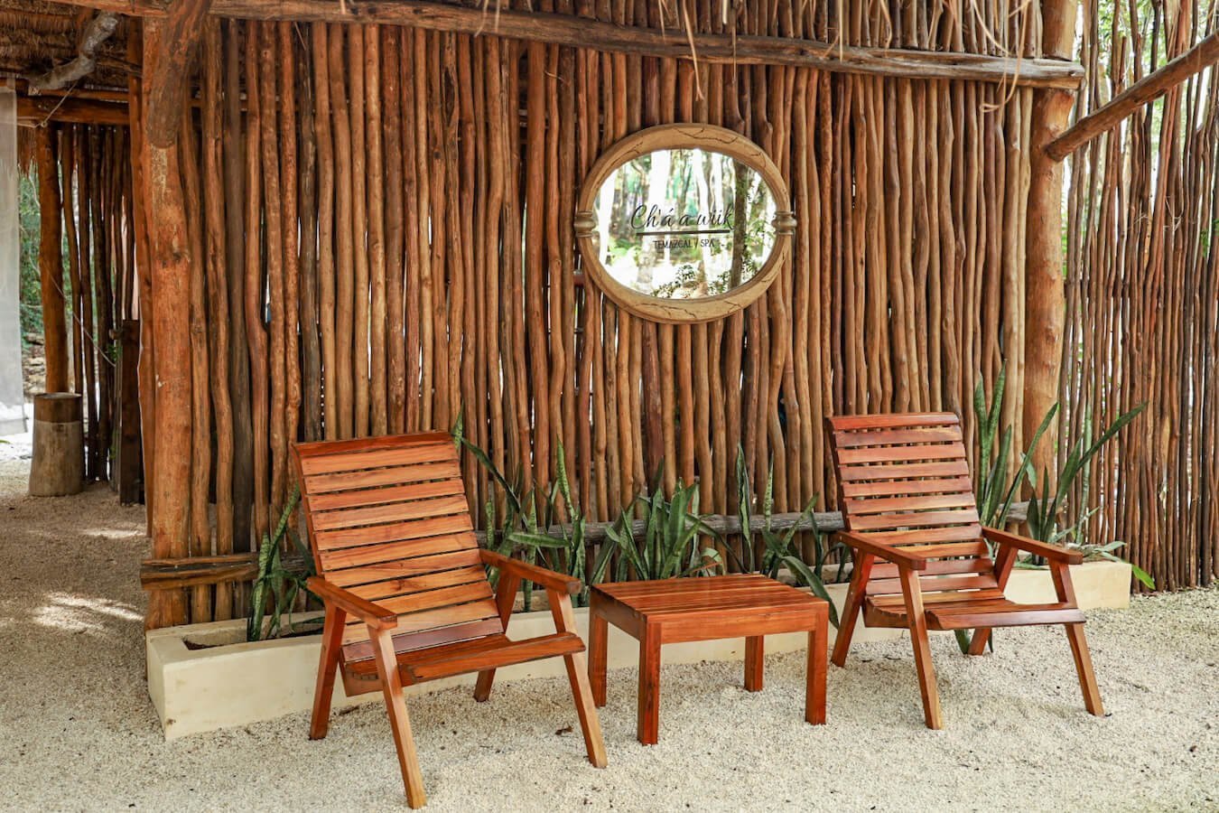 The wooden outdoor waiting area of the Spa at the Cenote Secreto Maya
