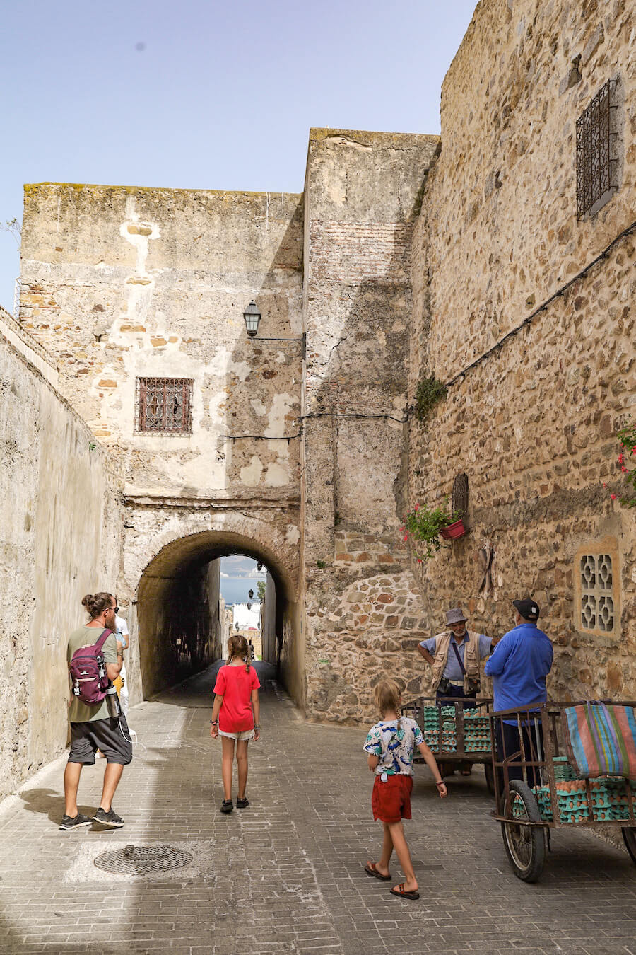 A family walk through the historical Kasbah in Tangier. Taking a day trip to Tangier in Morocco from the South of Spain is a great thing to do.  