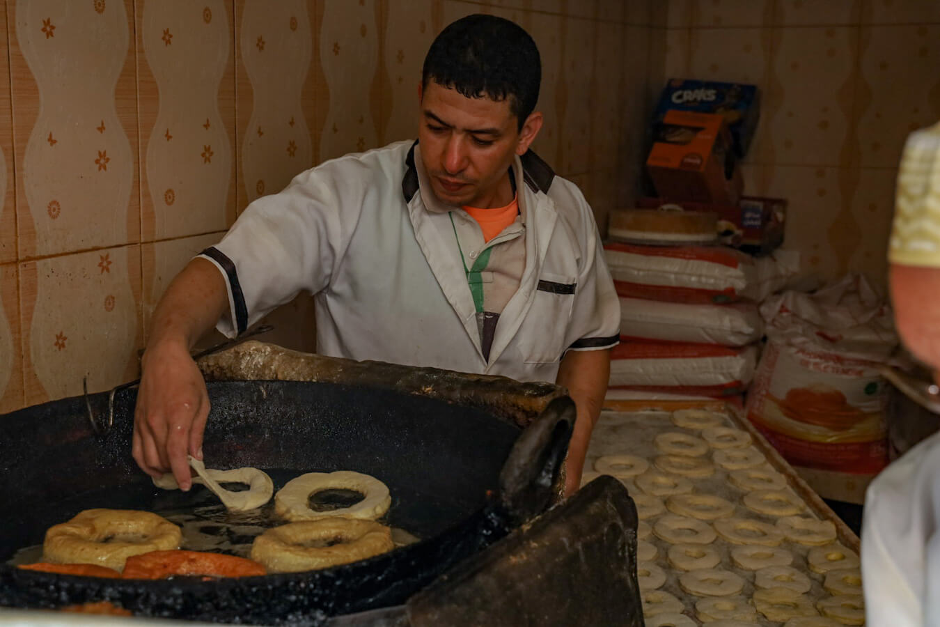 Donuts are cooked fresh in a small road side street food kitchen in Essaouira medina