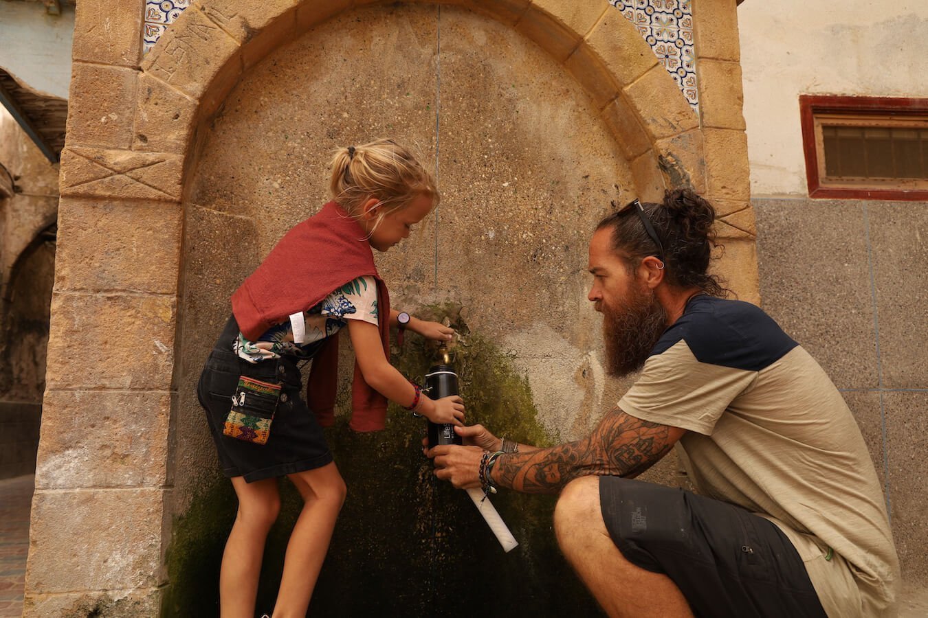 Filling a Life Straw filter bottle from the water stations in Essaouira medina