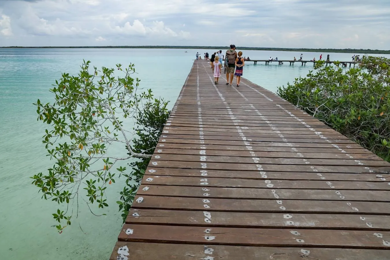 A family walk the pier at Eco Parque