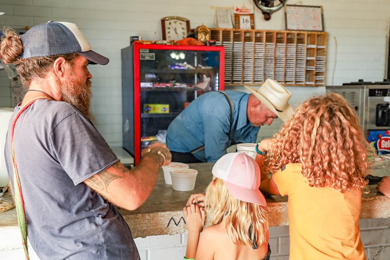 A father buys his kids ice cream at Salamanca from the mennonite community.