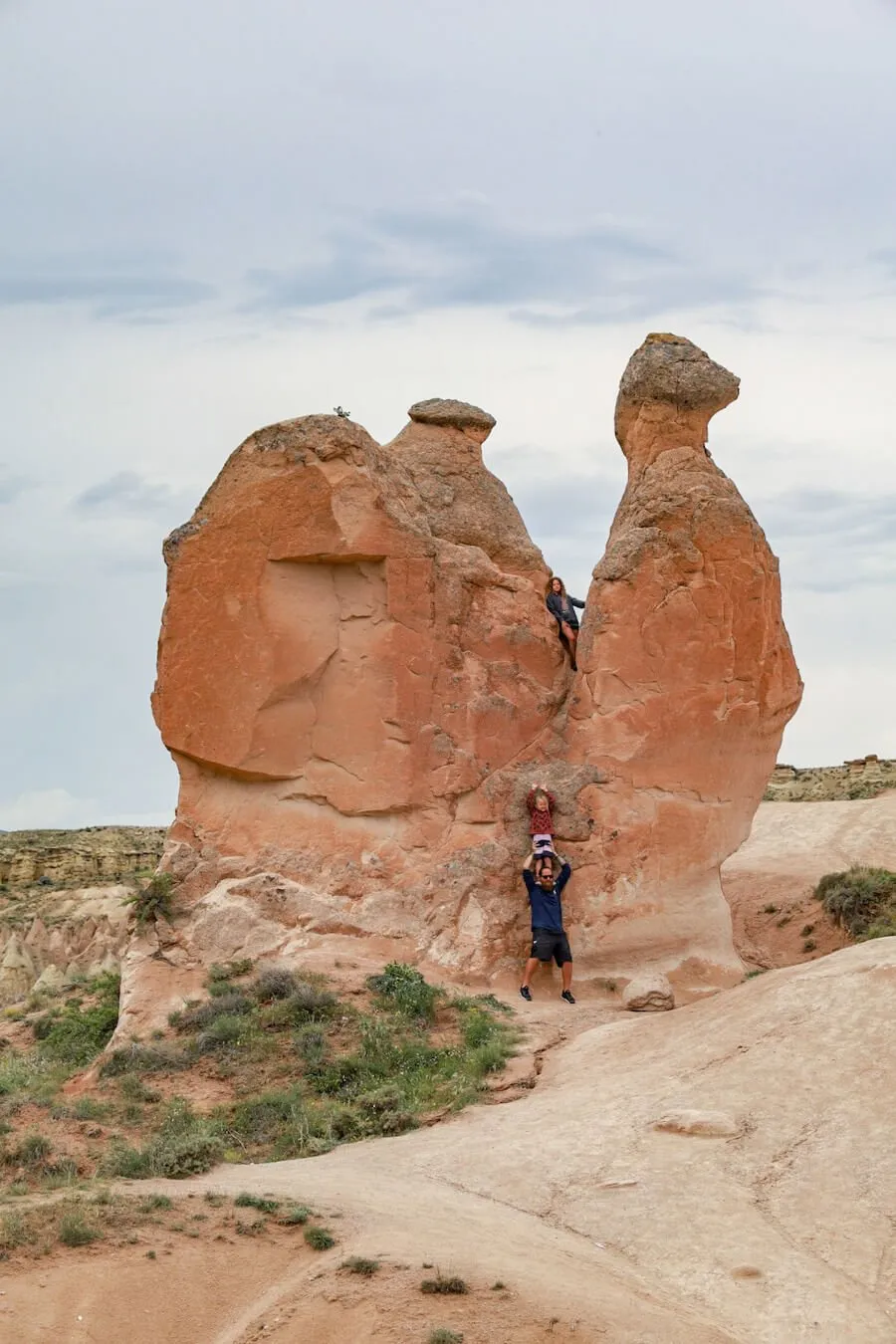 Children climb the rock formations in Devrent Valley also know as Imagination Valley - one of the best things to do in Cappadocia with kids is walk this valley.