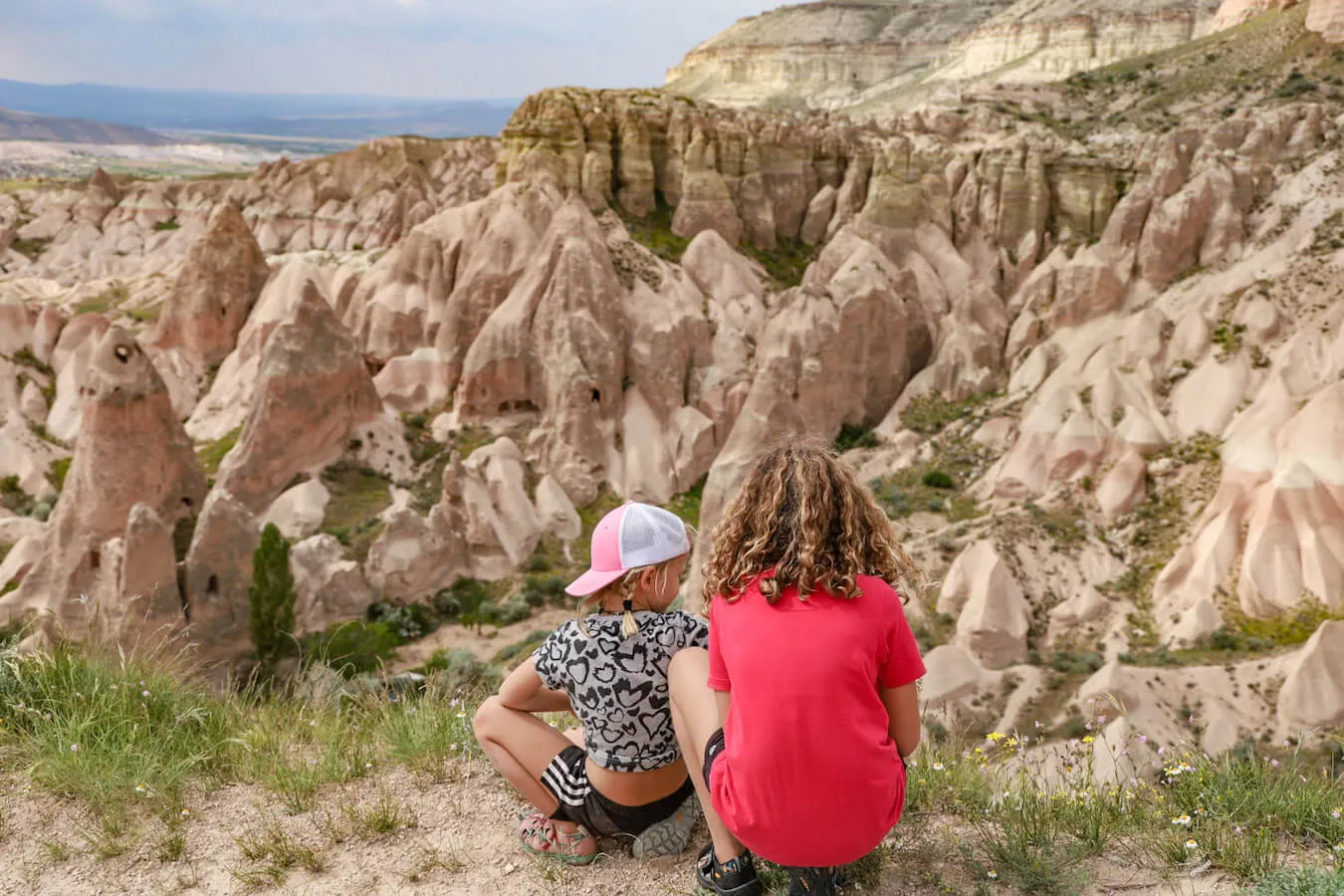 Children hiking Rose valley look out at the view of rock formations and fairy chimneys.  Hiking is a very popular thing to do in Cappadocia.