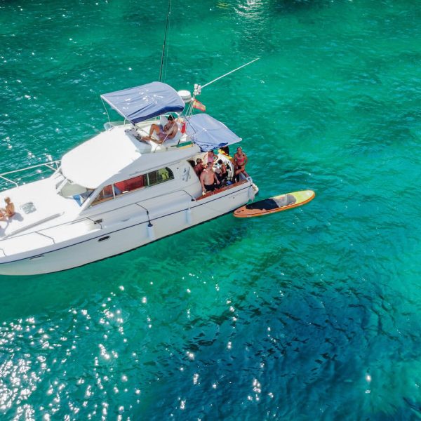 Holidaymakers on a boat tour in the Mediterranean sea in Javea Spain - one of the best things to do in Javea when on holiday