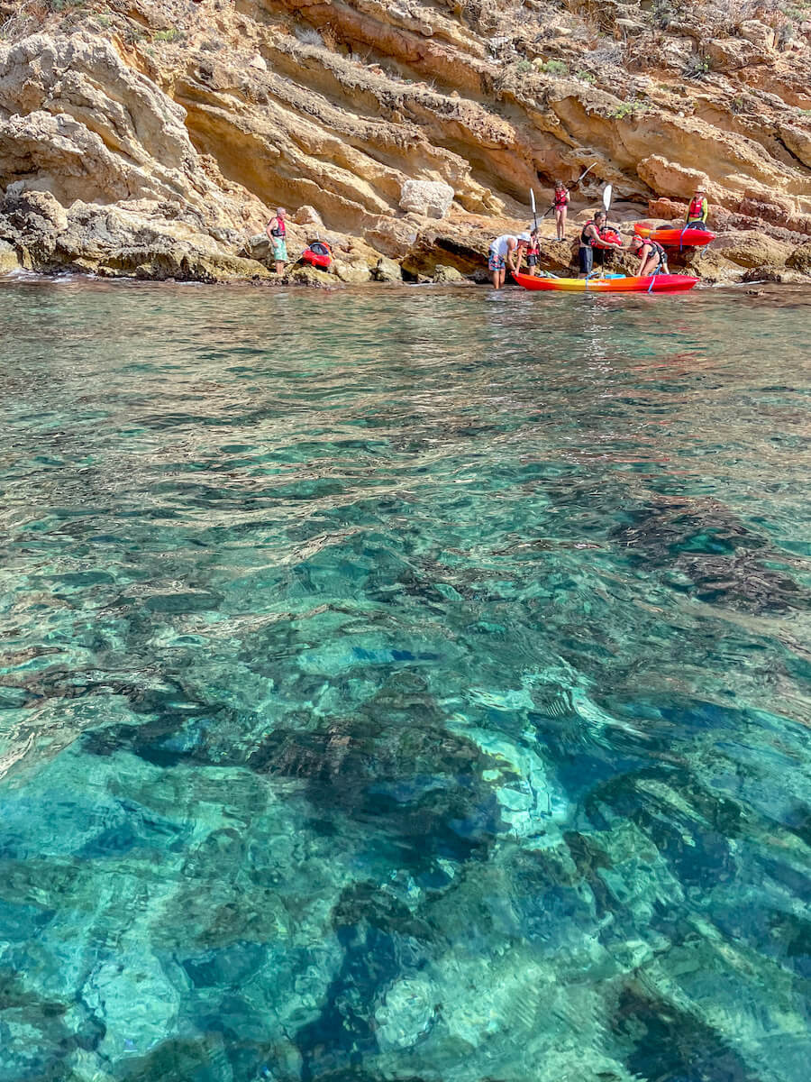 A group on a kayak and snorkelling tour in Javea - this activity is one of the best things to do in Javea / Xabia.