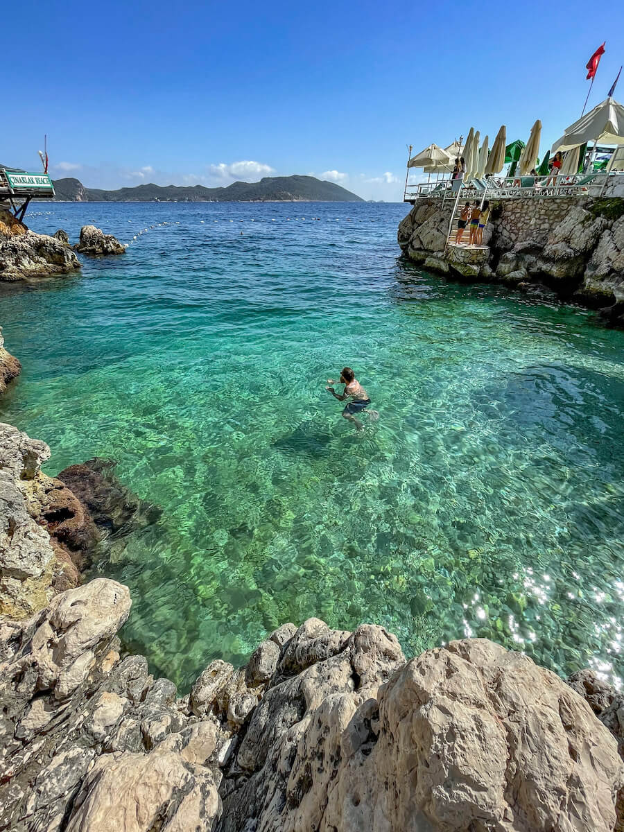 A man swims off Small Pebble Beach - things to do in Kas.