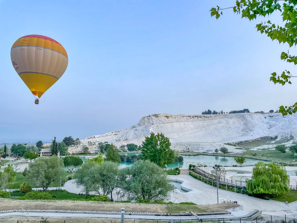 Hot air balloon flying over the white travertine terraces in Pamukkale - this is becoming an increasingly popular thing to do.