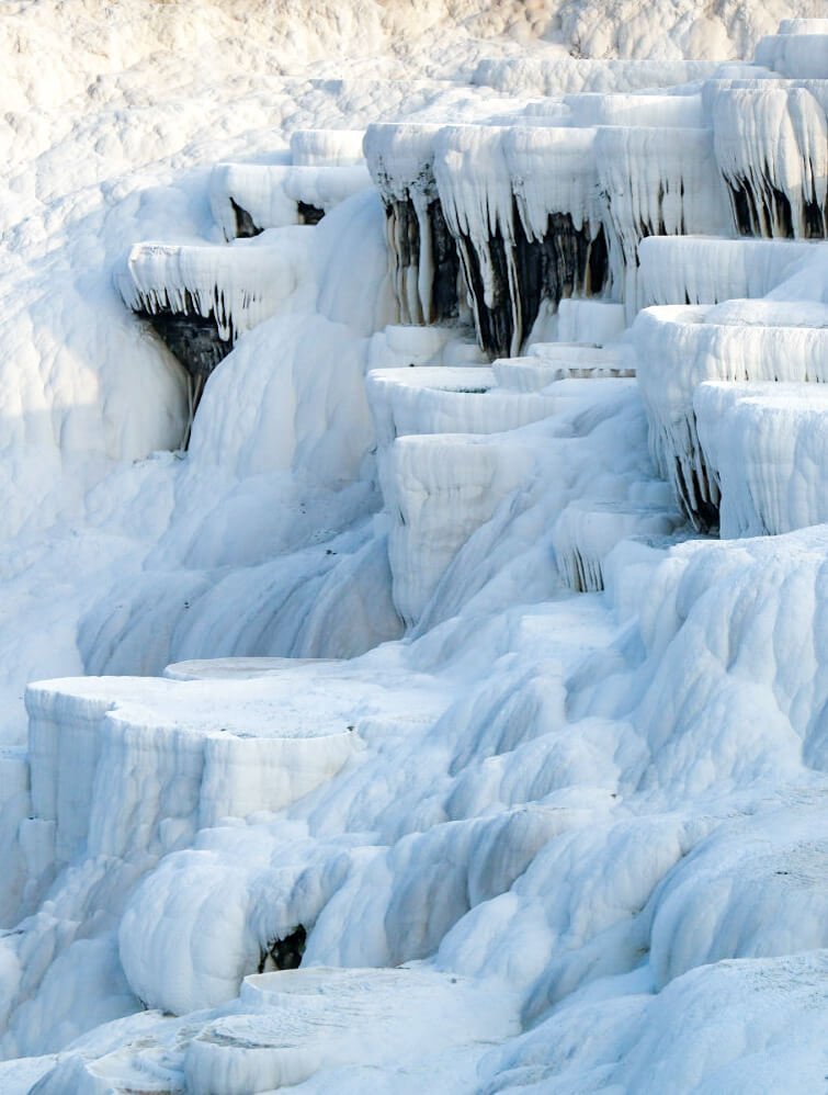 The travertine terraces photographed up close, the lime deposits appear like a frozen water fountain.