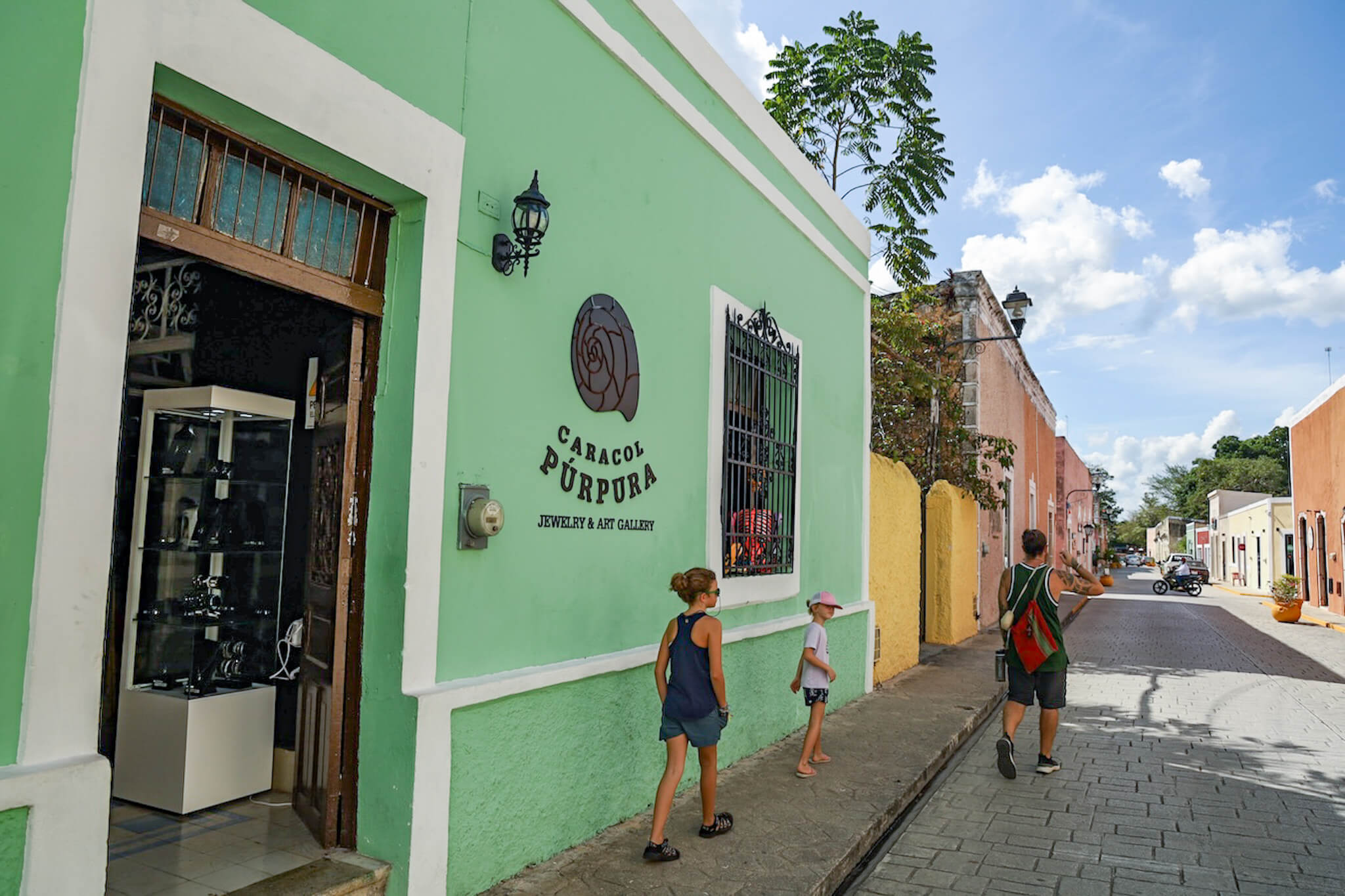 A family walk down the colourful street of Calzada de los Frailes in Valladolid looking for things to do.