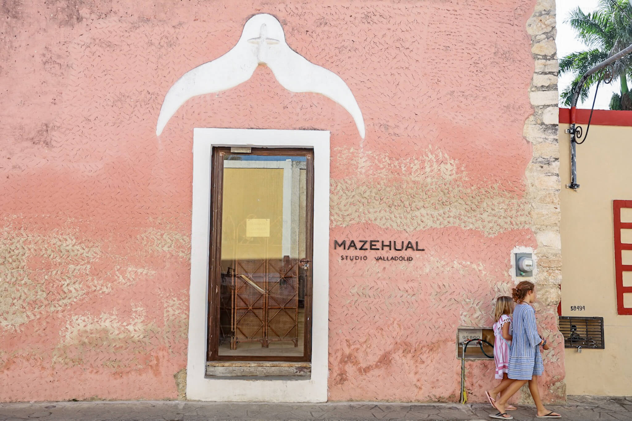 Kids walking through Valladolid town in Mexico along Calzada de Los Frailes - one of the best streets to visit and things to do in Valladolid