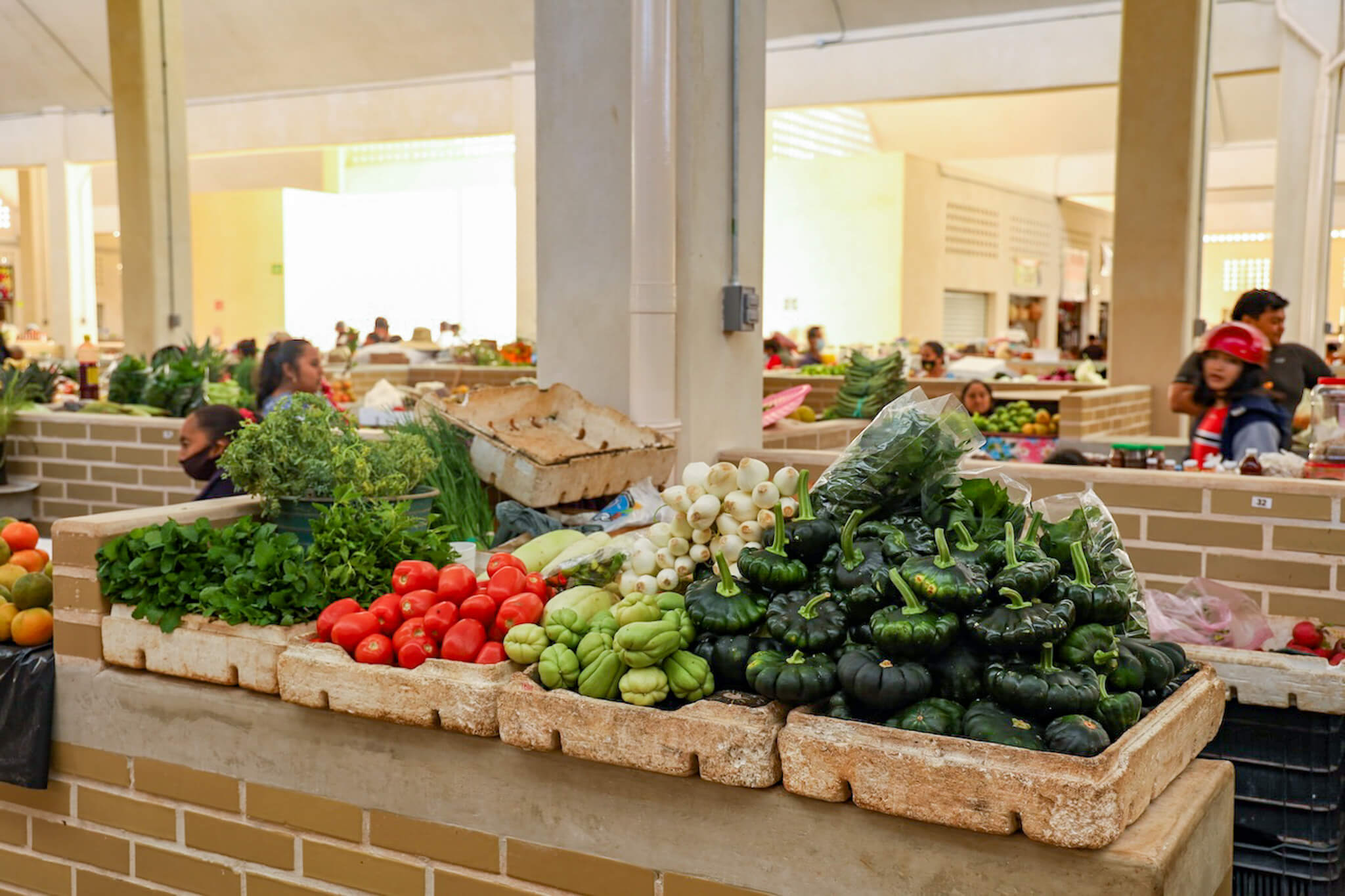 A vendor sells vegetables at the Mercado Municipal in Valladolid - a great place to visit when on holiday