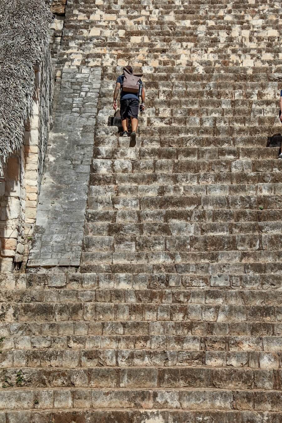 A man walks up the steep stairs of the Ek'Balam ruins near Valladolid - a great thing to do when visiting Valladolid