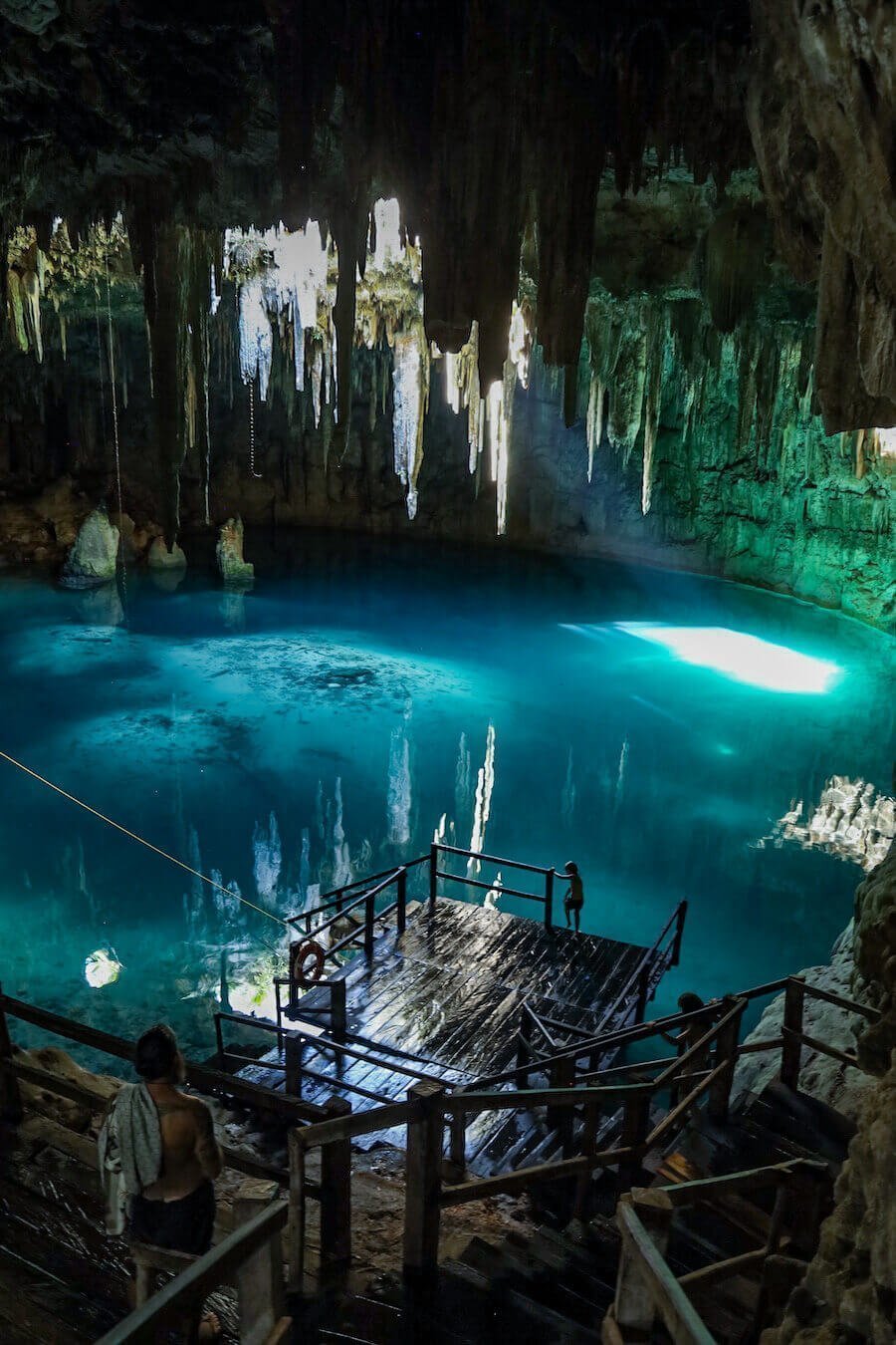 A family admire the blue waters of the closed Xcanahultan Cenote near Valladolid - visiting cenotes is a popular thing to do in Valladolid
