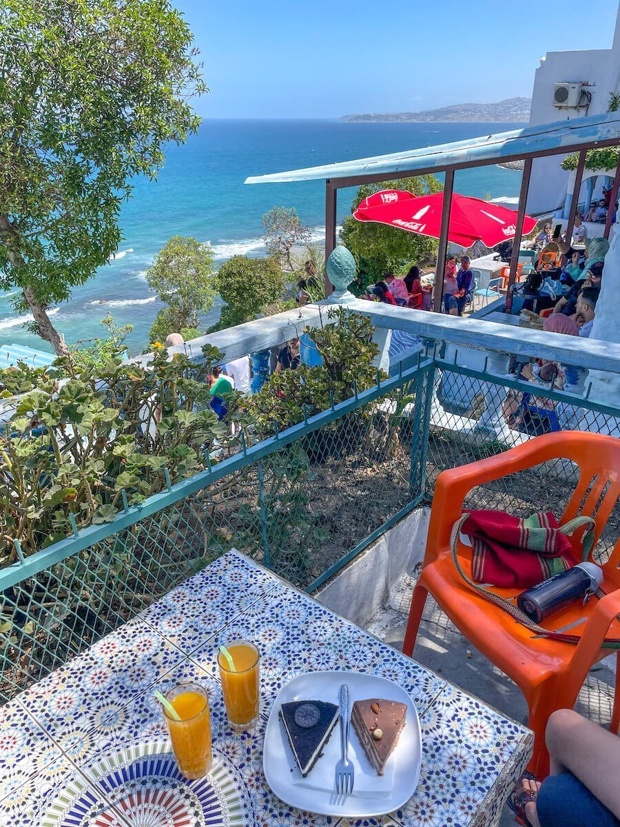 A table with orange juice and cake at the iconic cafe Hafa