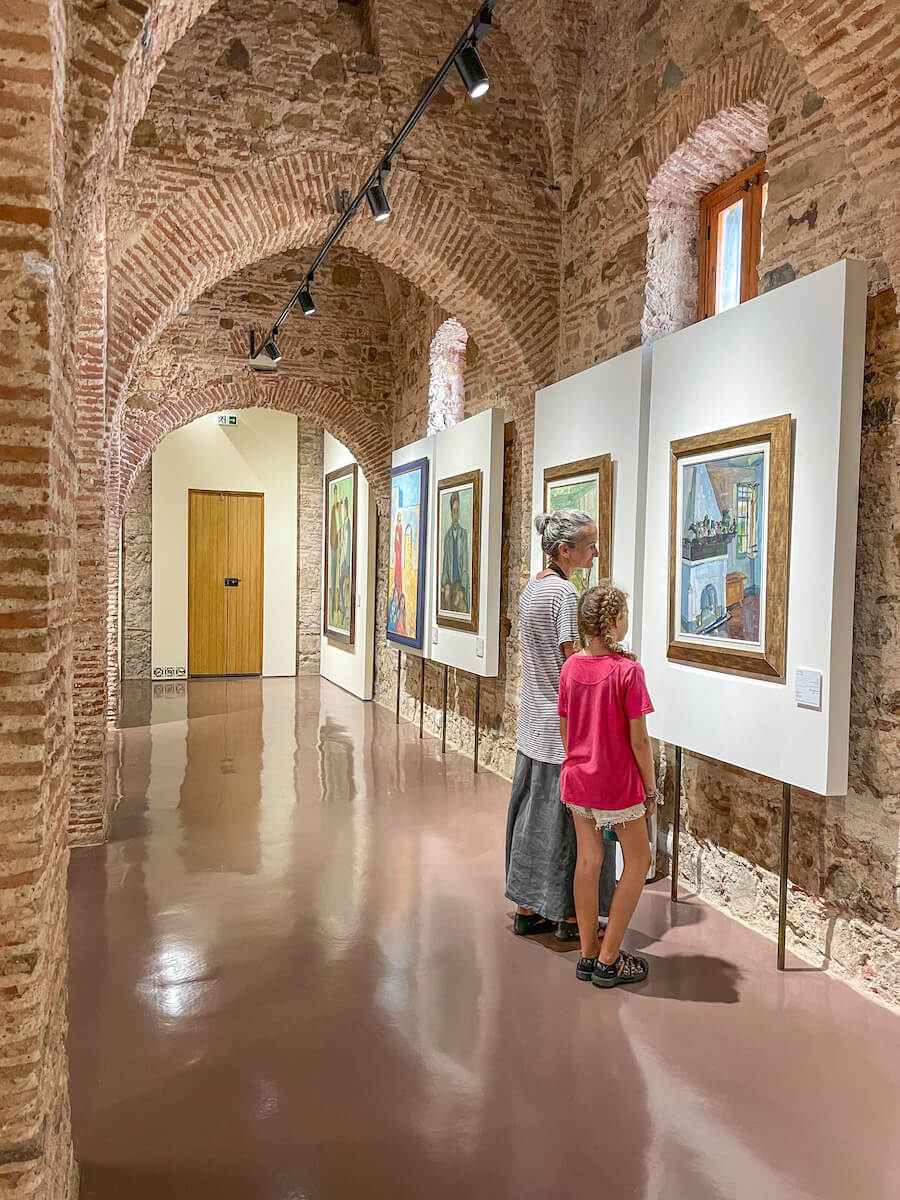 A mother and child admire paintings with the Contemporary Art Museum in Tangier, one of the top things to do on a Tangier itinerary