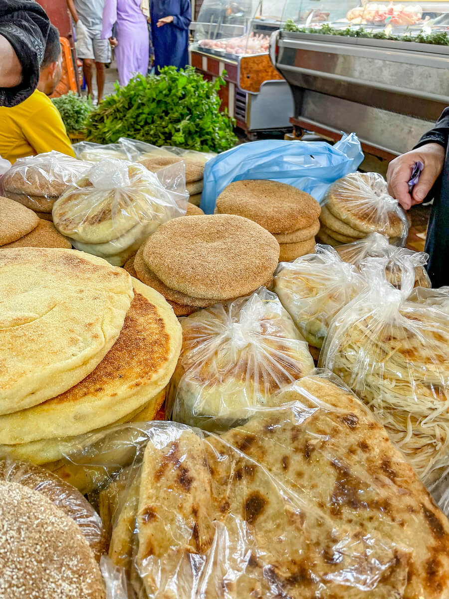 Harcha and other traditional breads for sale at the fresh fruit and vegetable market in the medina in Tangier - visiting the markets is one of the top things to do.