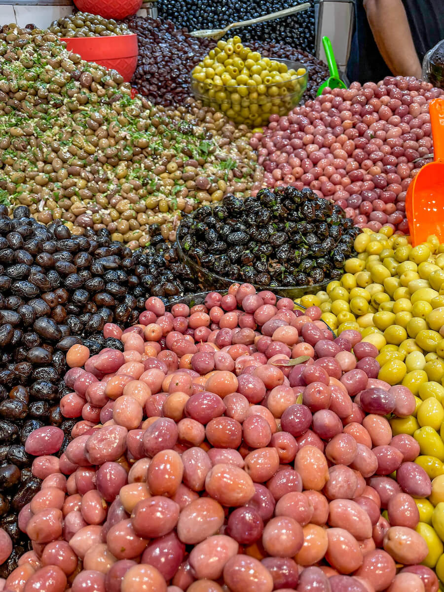 Piles of olives available for sale in the medina in Tangier - one of the best places to visit for a Tangier itinerary