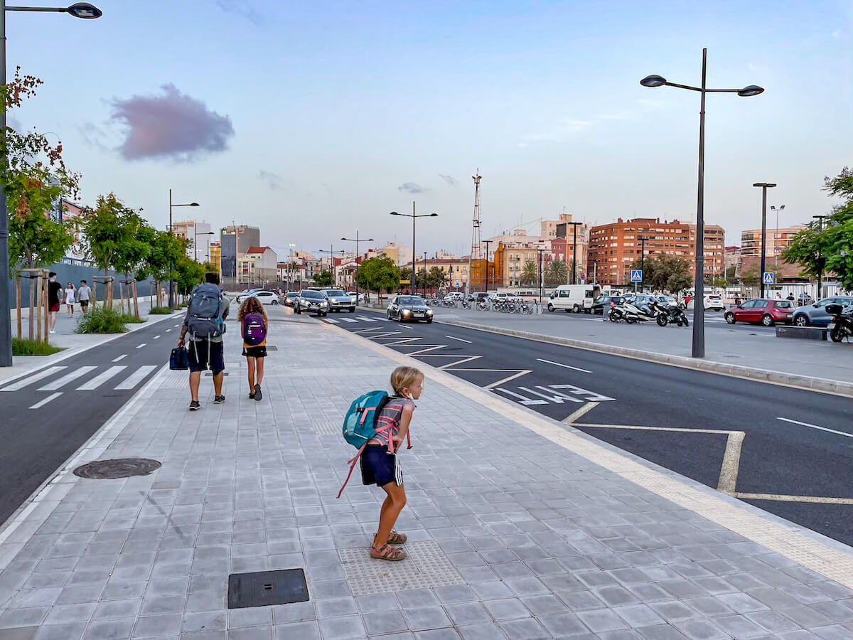 A family with their luggage walking between the bus and metro station on their way from Javea to Valencia