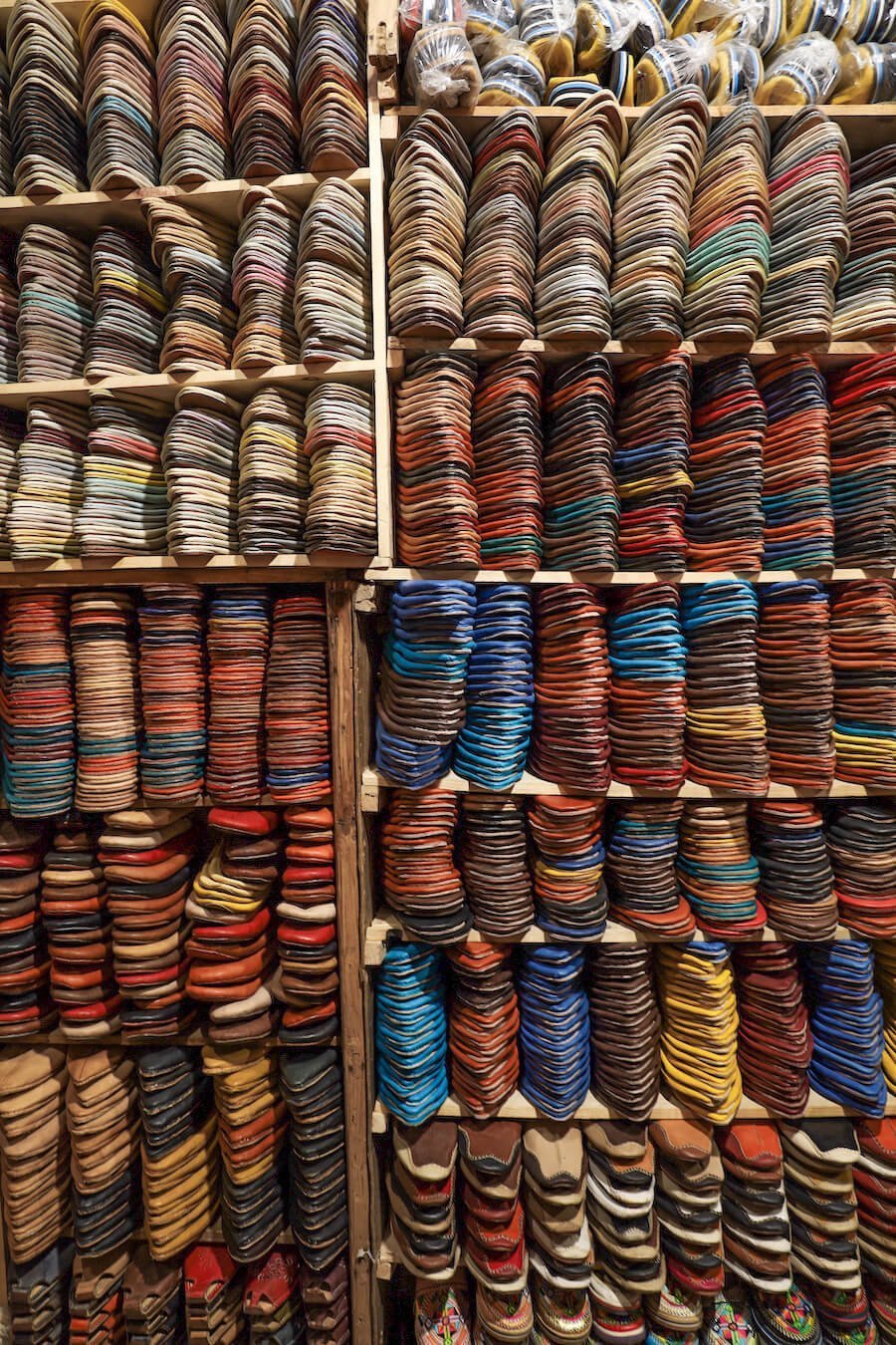 Leather shoes fill the shelves of a leather shop in the Fes Medina