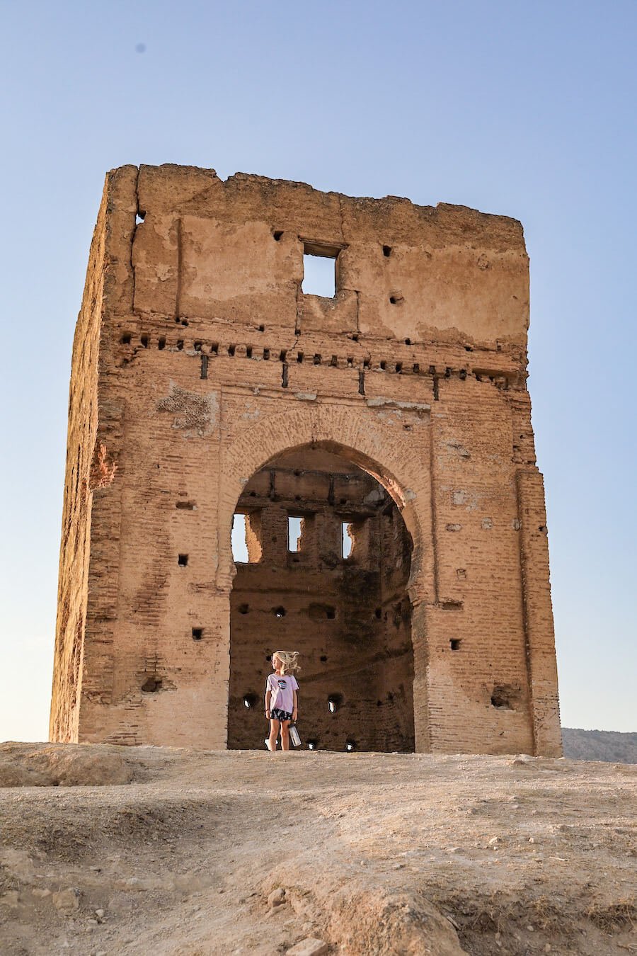 A young child stands at the Marinid Tombs in Morocco on a guided walking tour in Fes