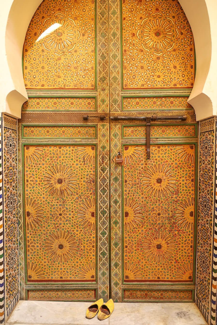 A brightly painted yellow door in the Fes Medina photographed while on a walking tour in Fes el-Bali