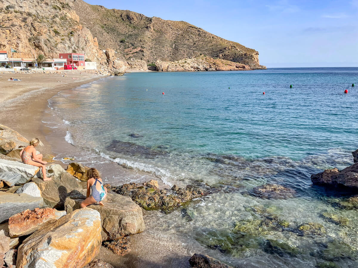 Kids play on the beach in Portus near Cartagena in Spain.