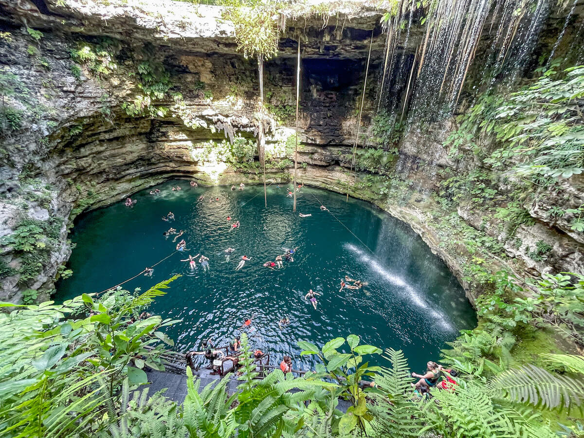 People swim in the beautiful Cenote Saamal at Selva Maya - one of the best cenotes near Valladolid