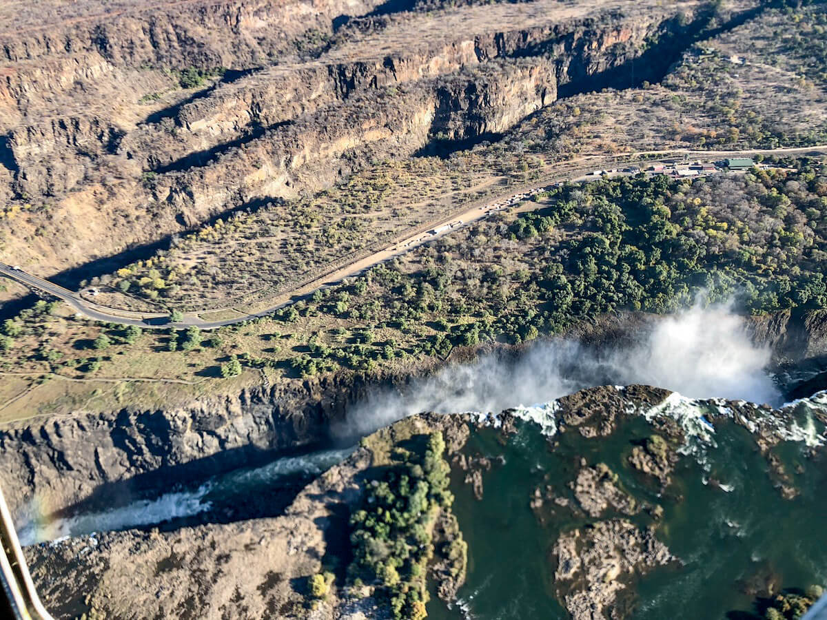 Victoria Falls and Bridge, and the Zambia / Zimbabwe border crossing as seen from above on a helicopter ride and tour