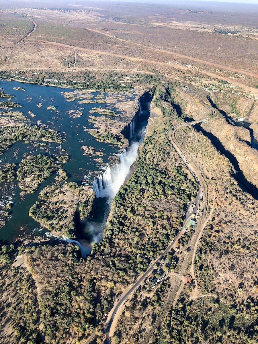 The deep ravines of the Victoria Falls, photographed from a helicopter flight and tour.  Also seen is the Victoria Falls Bridge and the border crossing from Zimbabwe to Zambia.