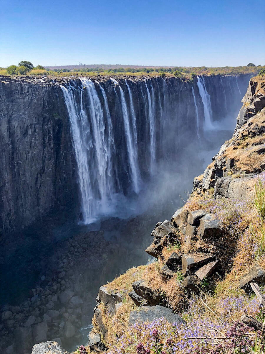 Water falls over the impressive Victoria Falls, seen from the Zimbabwe side.